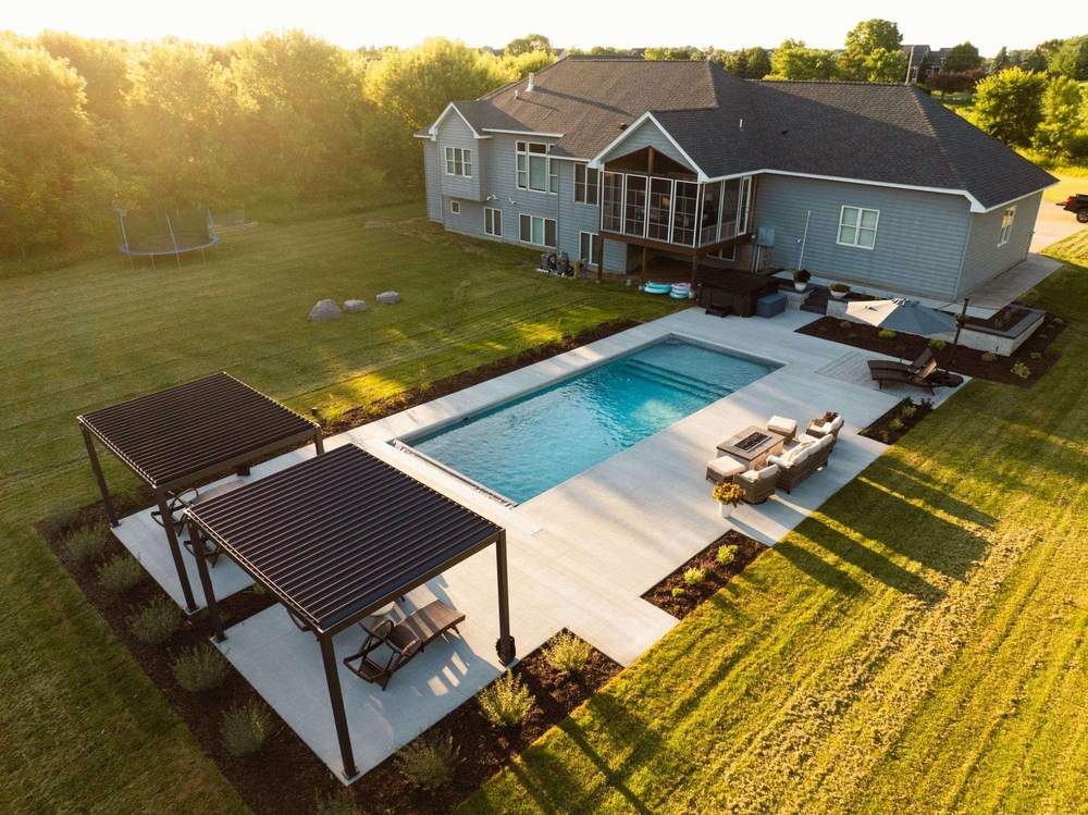 Aerial view of pool, pergolas and paver patio